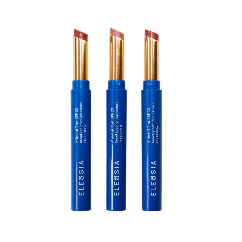 Three Eleusia lip tint products with blue casings on a white background