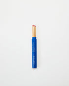Blue Eleusia lip tint with pink cap on a white background