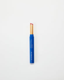 Blue Eleusia lip tint with pink cap on a white background