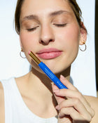 ELEUSIA Mineral Lip Tint SPF 20 in Mastic Rose model holding in hand