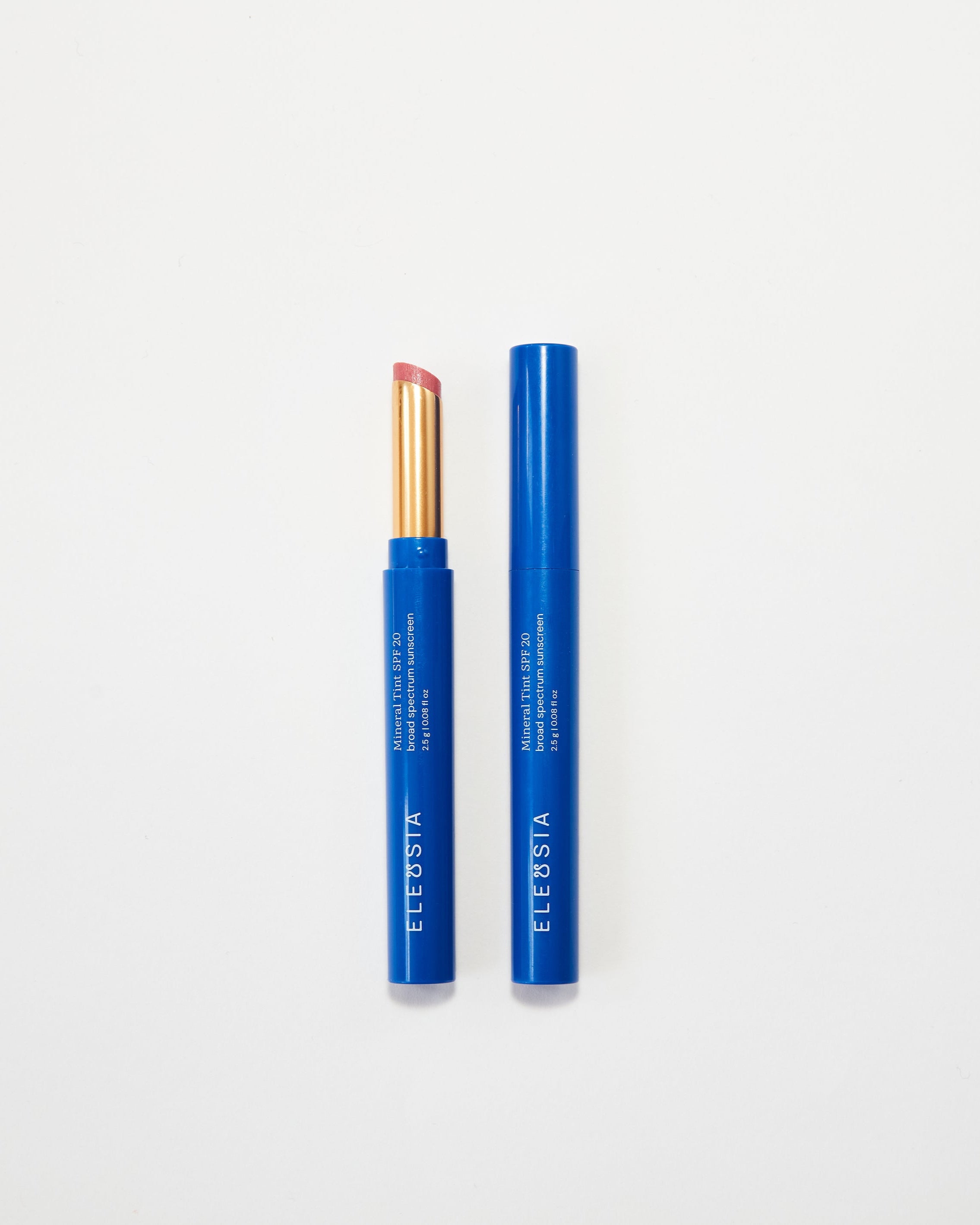 Two blue Eleusia lip products with visible branding on a white background