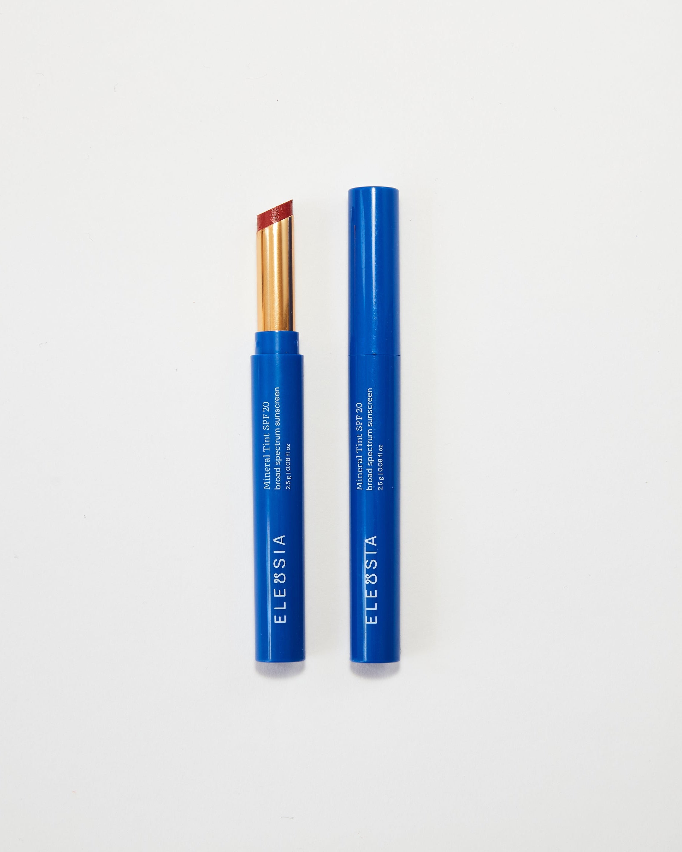 Two blue lip products with visible brand name on a white background